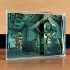 Join Solid Snake as you infiltrate a cargo tanker as you sneak past guards, peek around corners and subdue enemies to take down the Sons of Liberty in Konami's masterpiece Metal Gear Solid 2: Sons of Liberty in a whole new dimension. Each piece is printed on 3/4" thick optical-grade acrylic with vibrant UV cured inks and measures 4 1/2" x 6" Officially licensed by Konami Metal Gear Solid Snake, Sons Of Liberty, Solid Snake, Metal Gear Solid, Metal Gear, Paperweights, Popular Culture, Les Oeuvres, Collectibles