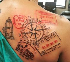 the back of a woman's shoulder with tattoos on it and an image of a compass