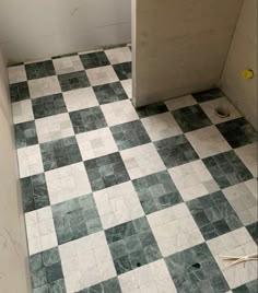 the bathroom floor is covered in black and white tiles