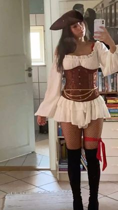 a woman in a pirate costume taking a selfie