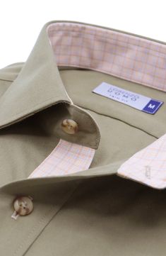 This button-up shirt features a trim fit that gives you more definition while the cotton design ensures lasting comfort. Front placket Spread collar Long sleeves with button cuffs Contrast pattern inside collar and inside placket Contrast roll-up tabs 100% cotton Machine wash, tumble dry Imported Khaki Spread Collar Top With Button Cuffs, Fitted Cotton Dress Shirt With Casual Collar, Khaki Tops With Button Cuffs And Spread Collar, Khaki Top With Button Cuffs And Spread Collar, Fitted Khaki Button-up Shirt, Classic Khaki Cotton Shirt, Fitted Collared Shirt With Functional Buttons, Khaki Button-up Shirt With Button Cuffs, Slim Fit Shirt With Casual Collar And Placket