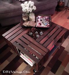 a coffee table made out of pallet wood with flowers in the center and jars on top