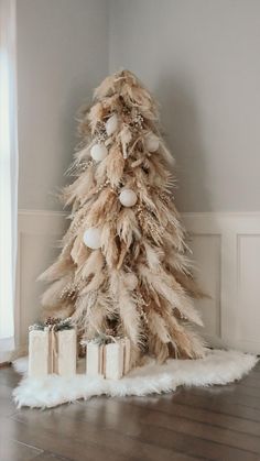 a white christmas tree with presents under it