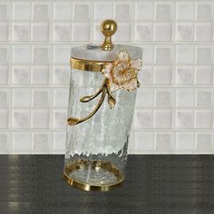 Expertly crafted with hammered glass, this canister features a stunning white enamel and gold leaf flower design. The luxurious marble lid, complete with a gold knob, adds an elegant touch. Available in three sizes to suit your storage needs. Elevate your home with this beautiful and functional piece. Available in 3 sizes, sold separately. Red Barrel Studio® | Red Barrel Studio® Hammered Glass Canister w / White Enamel & Flower w / Leaf, Marble Lid 11.25 H x 3.0 W x 3.0 D in pink / white / yello Kitchen Cabinets Storage Organizers, Gold Knobs, Glass Canisters, Enamel Flower, Christmas Kitchen, Leaf Flowers, Gold Enamel, Gold Flowers, White Enamel