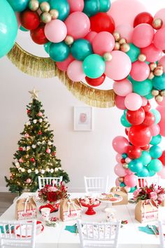 the table is set with balloons and presents