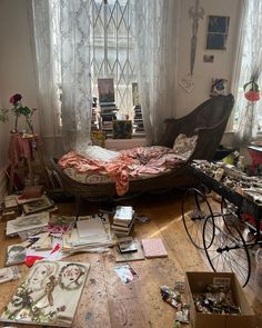 a messy bedroom with an unmade bed and lots of papers on the floor next to it