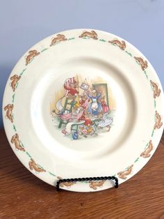 a plate with an image of alice and the neverlander on it sitting on a table