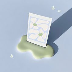 a piece of paper sitting on top of a puddle of green liquid next to a white object