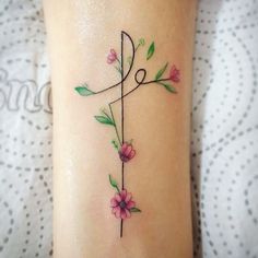 a tattoo on the leg of a woman with pink flowers