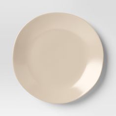 an empty white plate on a gray background