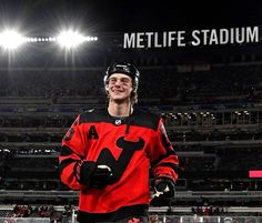 a hockey player is standing in front of the stadium