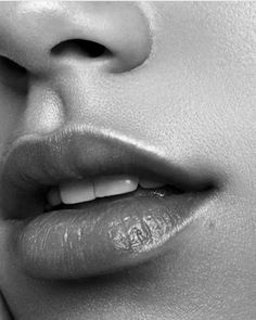 a woman's lips and nose are shown in black and white