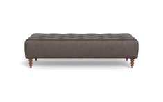 a gray bench with wooden legs and an ottoman on the bottom, in front of a white background