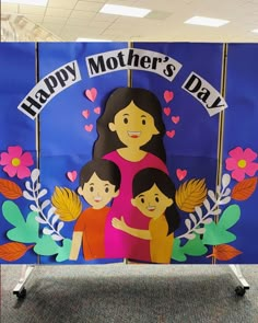 a mother's day sign with two children on it in an office cubicle