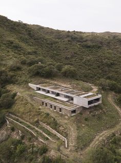 an aerial view of a house on top of a hill