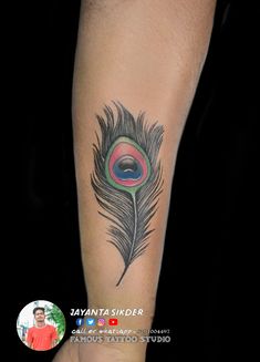 a man with a tattoo on his arm has a colorful peacock feather tattooed on it