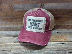 Bad Decisions Make Good Stories is a Funny Hat For Women. These Distressed Ponytail Hat are perfect for a vacation or Girls Trip Gift or a great Friend Gift. Tattered Ponytail Hat 20% Cotton 80% Polyester Double Fabric Brim 7 Panel Hat Patches have frayed edges and are printed with permanent ink. They are adhered to the hat with an iron and strong double sided interfacing. While I do my very best to photograph items to see their true color, due to the nature of electronic devices sometimes color Distressed Adjustable Snapback Hat, Adjustable Distressed Baseball Cap, Distressed Curved Brim Hat, Distressed Trucker Hat One Size Fits Most, Trendy Distressed Hat For Outdoor, Distressed Adjustable Cap, Trendy Distressed Adjustable Hat, Adjustable Distressed Cap, Trendy Adjustable Distressed Hat