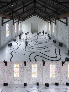 an art installation in the middle of a room with multiple windows and lines drawn on the floor