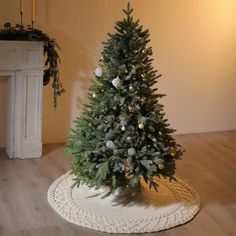 a small christmas tree sitting on top of a white rug