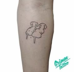 a small tattoo on the leg of a person with a dog sitting on top of it