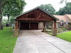 a large house with a covered driveway in the front yard