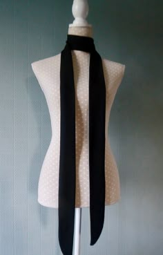 "Long and thin skinny scarf; a mod style tie to complement your outfit for a retro sixties look. Handmade from non crease, light jersey fabric with a good drape - so will hang neatly. This is a very versatile scarf that can be worn in several waystie, bow or belt. Made from quality jersey fabric and in a choice of two lengths and two colours - 70\"  or 80\" in dark blue or black The width is 2.5\" Lots more skinny scarves in my shop - search skinny scarves or browse the shop section: Skinny Scar Narrow Scarf, Scarf Outfit, Mod Style, Plaid Bow, Black Scarf, Scarf Tying, Mod Fashion, Cotton Set, Long Scarf