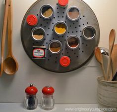 a wall mounted spice rack with spoons and utensils