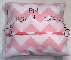 a pink and white pillow with the words pin here on it