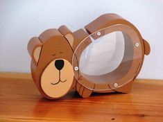 a brown bear shaped mirror sitting on top of a wooden table