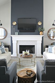 a living room filled with furniture and a flat screen tv mounted on the wall above a fireplace