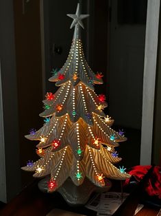 a lighted christmas tree sitting on top of a table