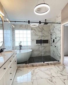 a large bathroom with marble floors and walls