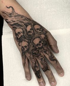 a man's hand with many skulls on it