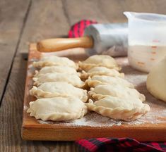 some dumplings are sitting on a cutting board