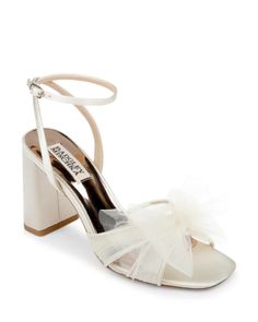 a women's white high heeled sandal with a bow on the ankle