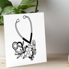 a black and white drawing of a stethoscope with flowers on it art board