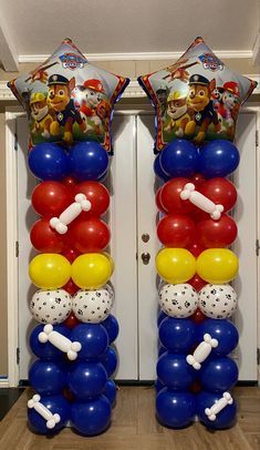 two balloons are stacked on top of each other in the shape of dogs and bones