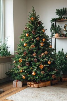 a small christmas tree in a living room with presents on the floor next to it