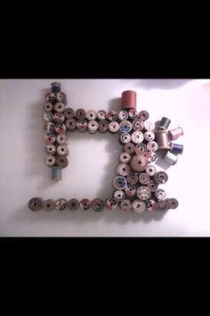 the letter p made out of sewing threads and spools