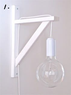 a light bulb hanging from the side of a wall