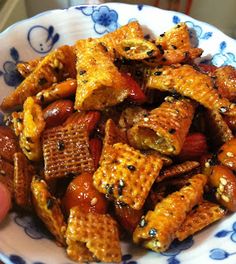 a bowl filled with cheetos sitting on top of a blue and white plate