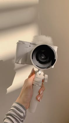 a person holding a camera up to the ceiling