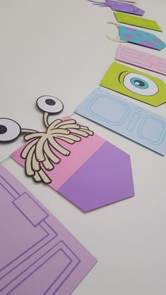 cut out paper shapes with eyes and eyeballs on them, sitting on a table