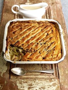 a casserole dish with broccoli and cheese in it on a wooden table