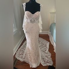 a wedding dress on display in a room