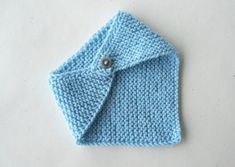 a blue knitted cloth with a button on it