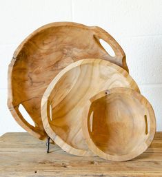 three wooden plates sitting on top of a wooden table