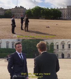 two men in suits are talking to each other and one man is standing on the ground