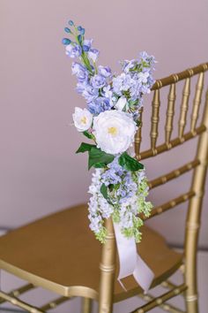 a bouquet of flowers sitting on top of a wooden chair