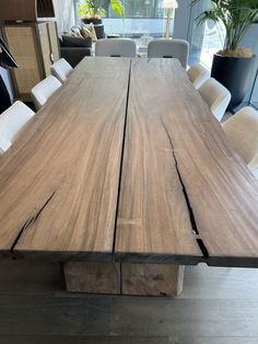 a large wooden table with white chairs around it